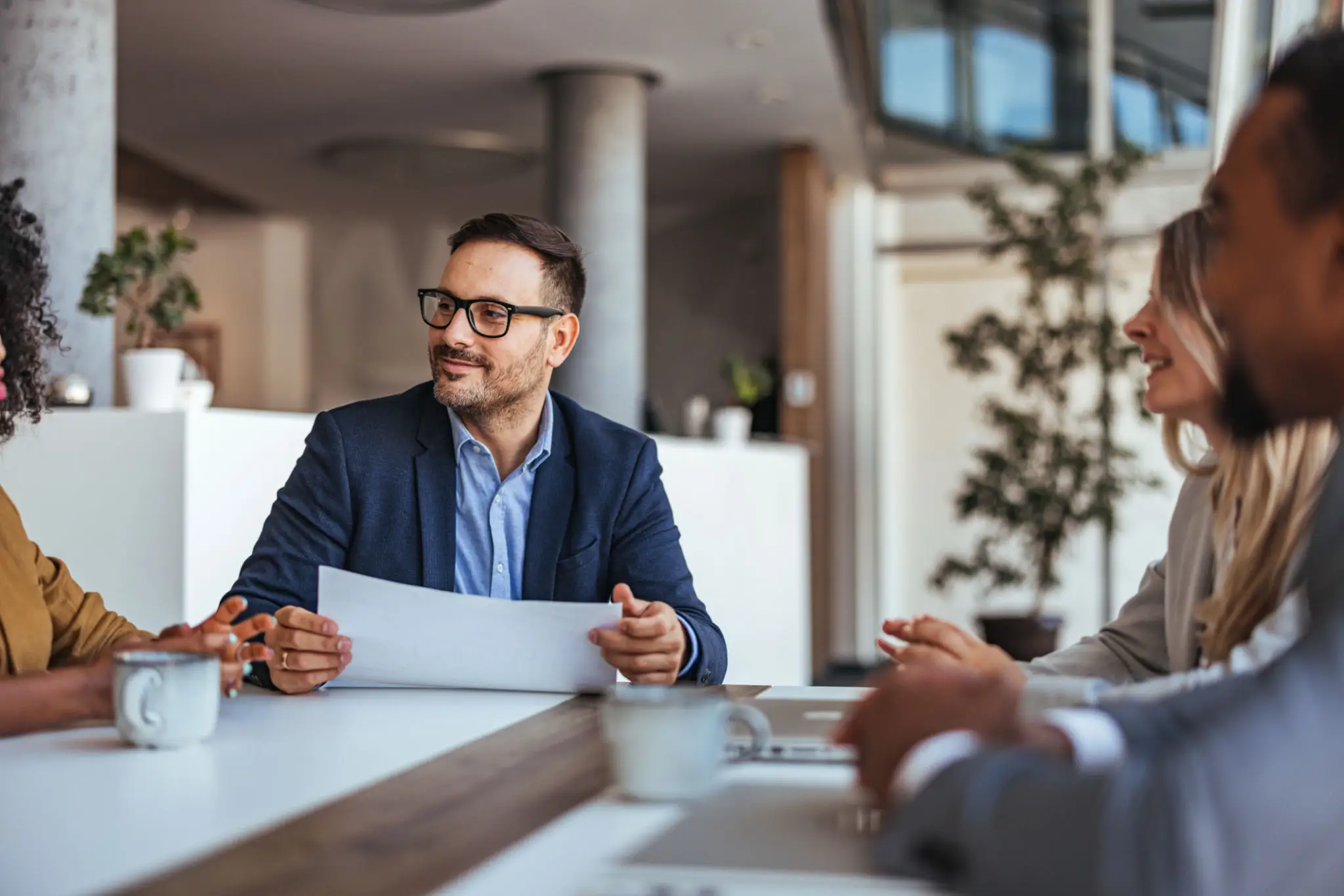 Businessman in a suit discussing ideas in a meeting room.