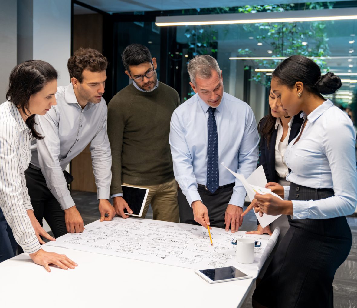 A group of professionals collaborating over a project blueprint.